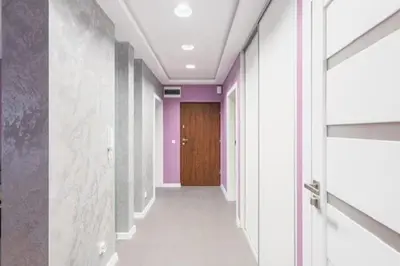 a hallway with purple walls and a wooden door at Niepołomice, kwatery, nocleg, pokoje,kwatery pracownicze in Niepołomice