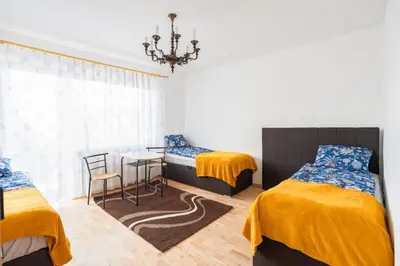 a bedroom with two beds and a table and chairs at Niepołomice, nocleg,noclegi,dla firm,dom, pokoje in Niepołomice