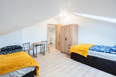 a bedroom with two beds and a table and chairs at Niepołomice, nocleg,noclegi,dla firm,dom, pokoje in Niepołomice
