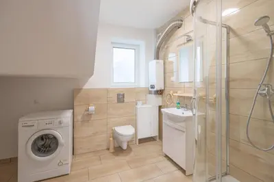 a bathroom with a washing machine and a washer at Niepołomice, nocleg,noclegi,dla firm,dom, pokoje in Niepołomice