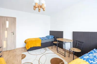 a room with two bunk beds and a table and chairs at Niepołomice, nocleg,noclegi,dla firm,dom, pokoje in Niepołomice