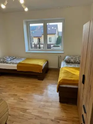 a room with two beds and a window at Niepołomice, nocleg,noclegi,dla firm,dom, pokoje in Niepołomice