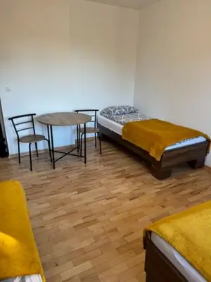 a bedroom with a bed and a table and chairs at Niepołomice, nocleg,noclegi,dla firm,dom, pokoje in Niepołomice