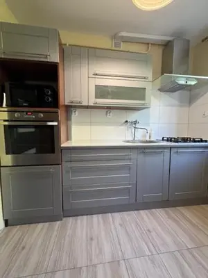a kitchen with stainless steel appliances and gray cabinets at Bochnia,kwatery pracownicze,duży dom, noclegi in Bochnia