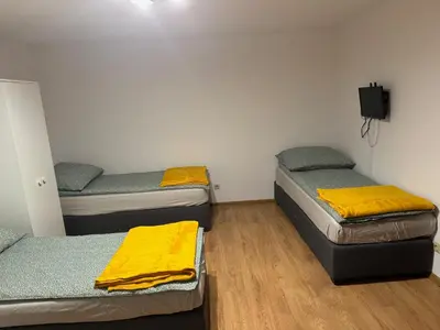 a room with three beds with yellow blankets on them at Łysokanie, Niepołomice , noclegi, kwatery dla firm, pokoje in Łysokanie