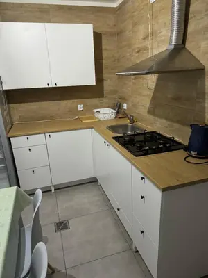 a kitchen with white cabinets and a stove top oven at Łysokanie, Niepołomice , noclegi, kwatery dla firm, pokoje in Łysokanie