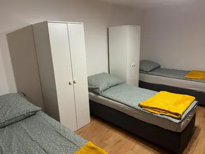 a bedroom with two twin beds and white cabinets at Łysokanie, Niepołomice , noclegi, kwatery dla firm, pokoje in Łysokanie