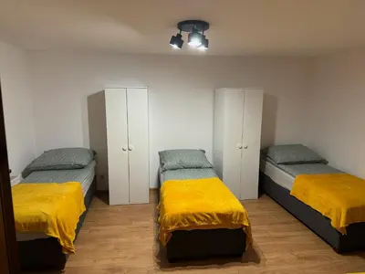 a bedroom with two beds with yellow sheets and cabinets at Łysokanie, Niepołomice , noclegi, kwatery dla firm, pokoje in Łysokanie