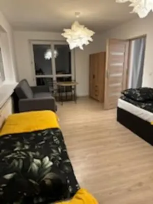 a living room with a bed and a couch in a room at Podłęże, Niepołomice, noclegi, kwatery pracownicze dla firm