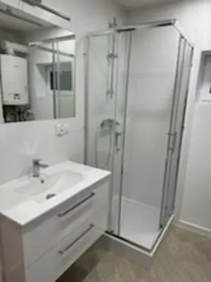 a white bathroom with a shower and a sink at Podłęże, Niepołomice, noclegi, kwatery pracownicze dla firm
