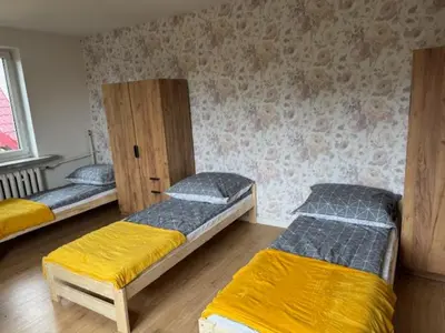 a room with three bunk beds in it at Niepołomice,noclegi, pokoje, cały dom, kwatery pracownicze in Niepołomice