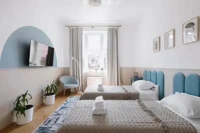 a bedroom with two beds and a window at Spacious City Centre Apartment - Słowackiego in Kraków