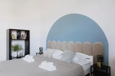 a bedroom with a large bed with two towels on it at Spacious City Centre Apartment - Słowackiego in Kraków
