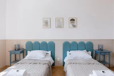 two beds sitting next to each other in a room at Spacious City Centre Apartment - Słowackiego in Kraków