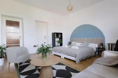 a living room with two beds and a couch at Spacious City Centre Apartment - Słowackiego in Kraków
