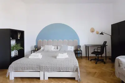 a bedroom with a large bed and a desk at Spacious City Centre Apartment - Słowackiego in Kraków