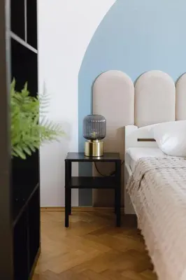 a bedroom with a bed and a side table at Spacious City Centre Apartment - Słowackiego in Kraków