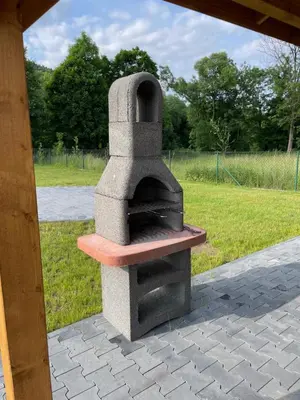 a stone pizza oven sitting on a patio at Apartament Zawoja in Zawoja