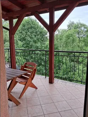 a wooden bench sitting on a screened in porch at Nocleg Wadowice 2 in Wadowice