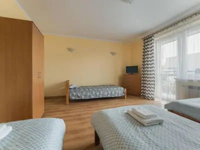 a hotel room with two beds and a window at Nocleg Wadowice 2 in Wadowice