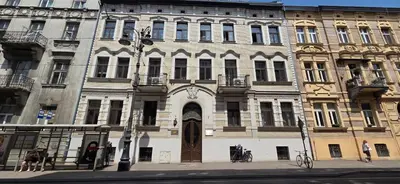 a large building with a door on a city street at Lightrooms Apartments in Kraków