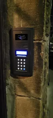 a pay phone on the side of a stone wall at Asnyk Prestige Apartments in Kraków
