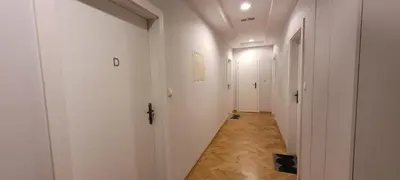an empty hallway with white walls and wooden floors at Asnyk Prestige Apartments in Kraków