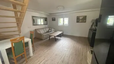 a living room with a couch and a table at Domek w Limanowej in Limanowa