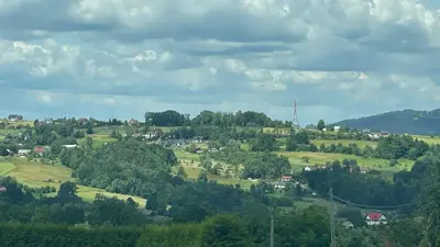 a town on a hill with trees and houses at Domek w Limanowej in Limanowa