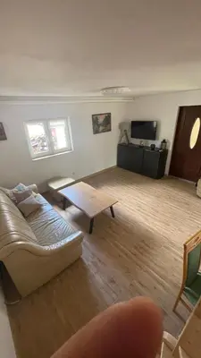 a living room with a couch and a table at Domek w Limanowej in Limanowa