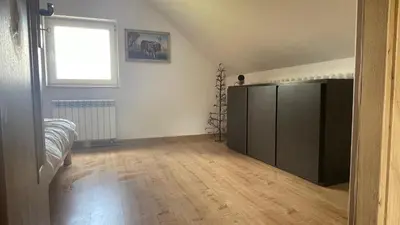 an empty living room with a large black cabinet at Domek w Limanowej in Limanowa