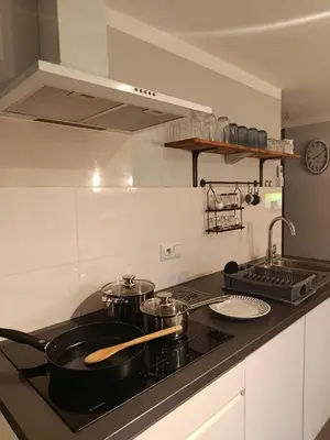 a kitchen with two pots and pans on a stove at EliBlue -Twój apartament in Trzebieńczyce