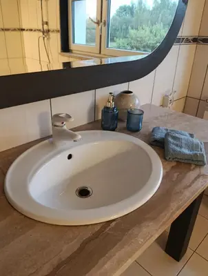 a white sink in a bathroom with a mirror at EliBlue -Twój apartament in Trzebieńczyce