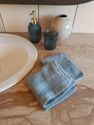 a towel sitting on a counter next to a sink at EliBlue -Twój apartament in Trzebieńczyce