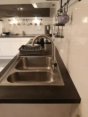 a sink in a kitchen with a mixer above it at EliBlue -Twój apartament in Trzebieńczyce