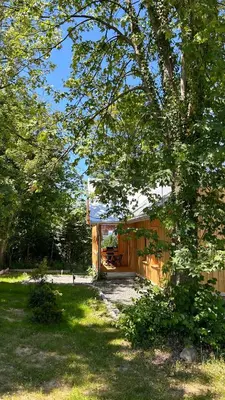 a house with a wooden fence in a yard at Rogaty Dworek in Kornatka