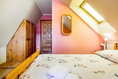 a bedroom with a wooden bed and a table at Agrozacisze in Zubrzyca Górna