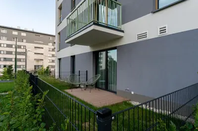 a balcony of a building with a table and chairs at Bohomolca Chic Studio with Garden by BookingHost in Kraków