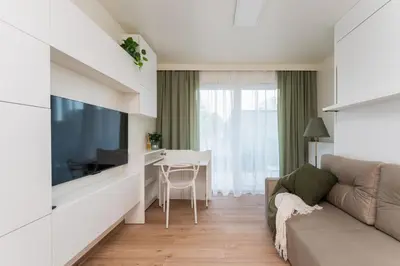 a living room with a couch and a table at Bohomolca Chic Studio with Garden by BookingHost in Kraków