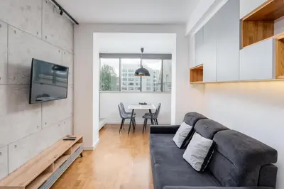 a living room with a couch and a table at Ariańska Comfort Apartment by BookingHost in Kraków