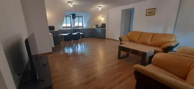 a living room with a couch and a table at Apartamenty Kraków-Bielany in Kraków