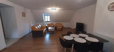 a living room with a table and chairs at Apartamenty Kraków-Bielany in Kraków