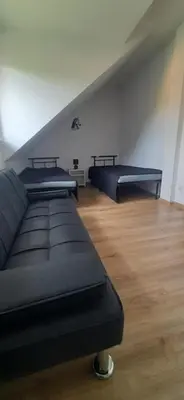 two beds in a room with a attic at Apartamenty Kraków-Bielany in Kraków