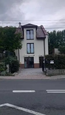 a white house on the side of a street at Apartamenty Kraków-Bielany in Kraków