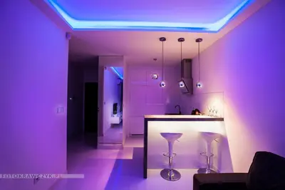 a purple kitchen with a bar and stools at Apartament Nadwiślańska in Kraków