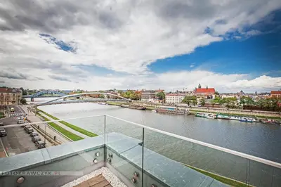 a view of a river with a bridge and a city at Apartament Nadwiślańska in Kraków