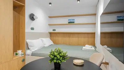 a small room with a bed and a table and chairs at Kluczborska Chic Studio by BookingHost in Kraków