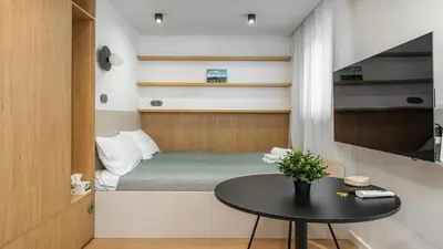 a small room with a small table and a bed at Kluczborska Chic Studio by BookingHost in Kraków