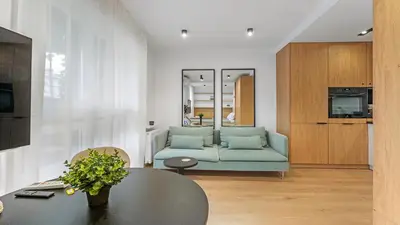 a living room with a couch and a table at Kluczborska Chic Studio by BookingHost in Kraków