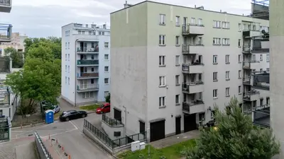 an apartment building in a city with a parking lot at Kluczborska Chic Studio by BookingHost in Kraków